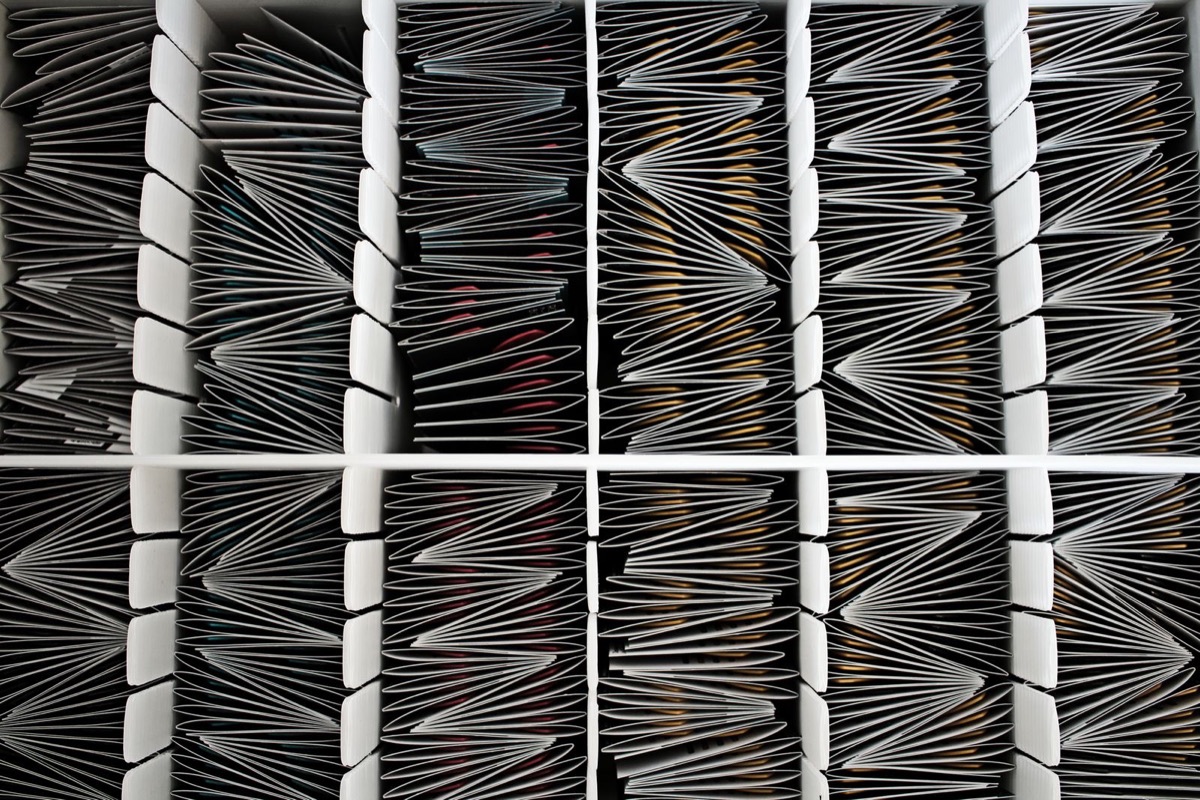 Rows of filed papers in shelf compartments, seen from above