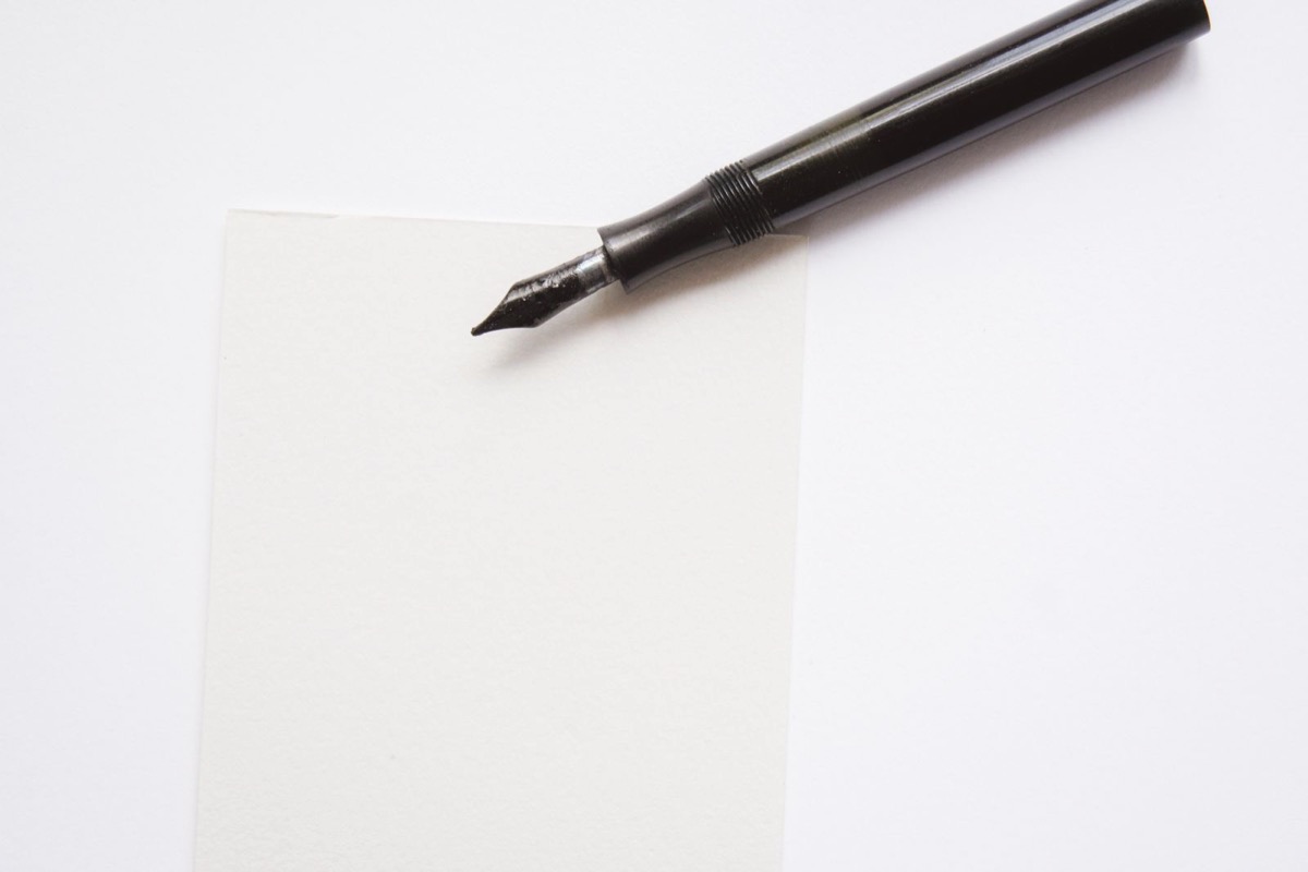 A fountain pen on a blank sheet of paper